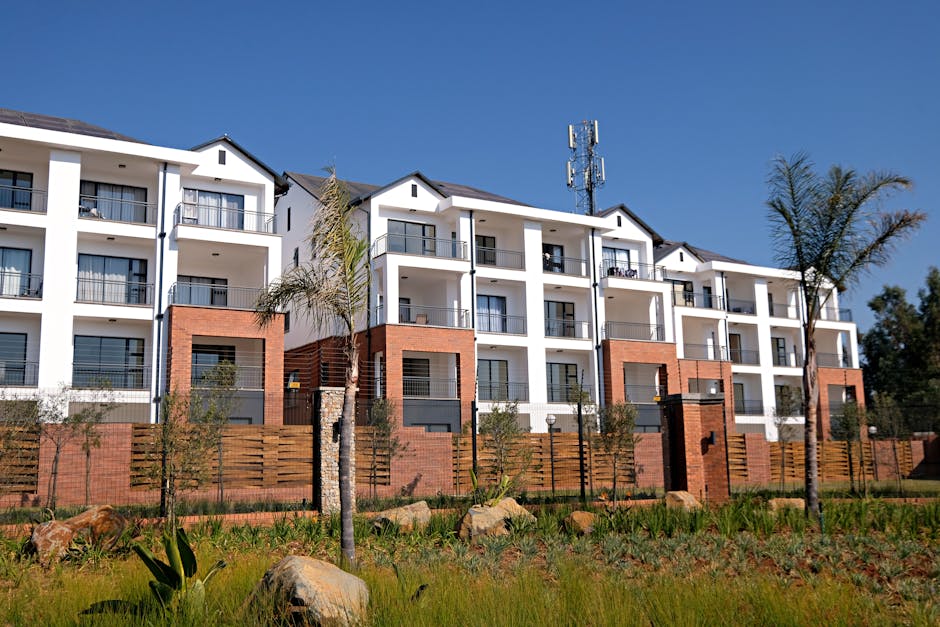Australian property crisis: apartment complex with garden, white facade, red brick.