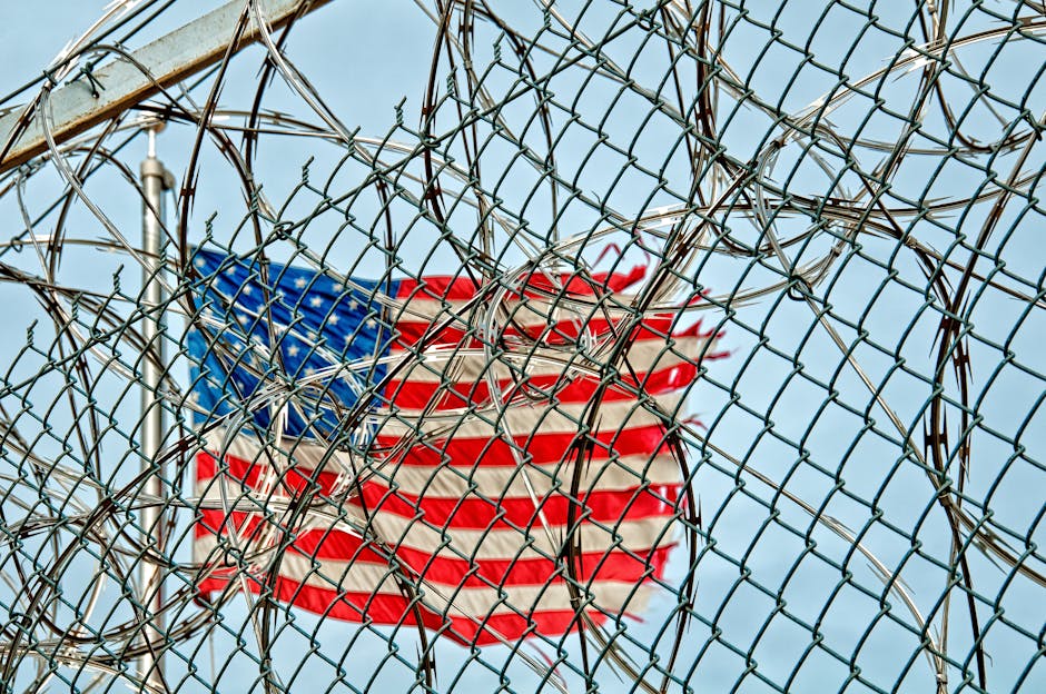 Australian deported: USA flag through barbed wire, symbolizing protection & freedom.